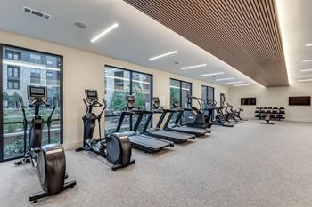 Fitness center with cardio theater, strength equipment, free weights and yoga/spin area with peloton bikes